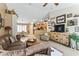 Inviting living room featuring tile floors, comfortable seating, and a view of the adjacent dining and kitchen areas at 1241 E Elm Rd, San Tan Valley, AZ 85140