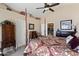 Main bedroom features vaulted ceilings, a four-poster bed, and a view into the kitchen and bath at 1241 E Elm Rd, San Tan Valley, AZ 85140