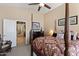 Spacious main bedroom with a four-poster bed, soft lighting, and an ensuite bathroom entrance at 1241 E Elm Rd, San Tan Valley, AZ 85140