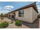 This beautiful backyard showcases desert landscaping and an inviting covered patio, perfect for relaxation and outdoor enjoyment at 1272 W Camina Buena Vis, Queen Creek, AZ 85140