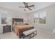 Comfortable bedroom with a ceiling fan, shutters, and a warm color scheme, offering a relaxing retreat at 1272 W Camina Buena Vis, Queen Creek, AZ 85140