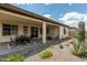 Enjoy the covered patio, complete with a dining area, lounge furniture, and desert landscaping, for ideal outdoor living at 1272 W Camina Buena Vis, Queen Creek, AZ 85140