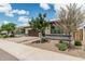 Charming single-story home featuring desert landscaping, a two-car garage, and mature trees at 1272 W Camina Buena Vis, Queen Creek, AZ 85140