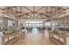 Spacious clubhouse interior with soaring ceilings, modern decor, and views of the pool area at 1272 W Camina Buena Vis, Queen Creek, AZ 85140