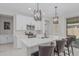 Well-lit kitchen with white cabinetry, stainless appliances, and a center island, perfect for entertaining at 1272 W Camina Buena Vis, Queen Creek, AZ 85140