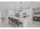 Bright kitchen featuring white cabinets, stainless steel appliances, and a spacious center island with seating at 1272 W Camina Buena Vis, Queen Creek, AZ 85140