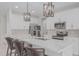 Contemporary kitchen with white cabinets, stainless steel appliances, and a large island with seating at 1272 W Camina Buena Vis, Queen Creek, AZ 85140