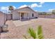 Backyard with covered patio, gravel landscaping, and block wall at 15802 W Watson Ln, Surprise, AZ 85379