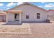 The backyard offers a covered patio and low-maintenance gravel at 15802 W Watson Ln, Surprise, AZ 85379