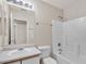 Bathroom showcasing a tub with white tile, a sink with vanity storage, and a mirrored wall cabinet at 15802 W Watson Ln, Surprise, AZ 85379