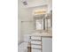 Bathroom features a single sink, a large mirror, and a tub/shower combo with neutral finishes at 15802 W Watson Ln, Surprise, AZ 85379