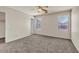 The carpeted bedroom features two bright windows and a closet, offering comfort and practicality at 15802 W Watson Ln, Surprise, AZ 85379