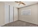 Cozy bedroom with carpeted floors, a window, and a closet with sliding doors at 15802 W Watson Ln, Surprise, AZ 85379