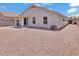 Exterior shot of the home showcasing the gravel landscaping and covered patio at 15802 W Watson Ln, Surprise, AZ 85379