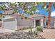 Charming single-story home with a two-car garage, desert landscaping and a red tile roof at 15802 W Watson Ln, Surprise, AZ 85379