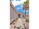 Charming single-story home with desert landscaping and palm tree at 15802 W Watson Ln, Surprise, AZ 85379