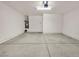 Clean garage offers ample space for parking and storage, complete with lighting and utility connections at 15802 W Watson Ln, Surprise, AZ 85379