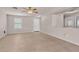 Bright and airy living room featuring neutral paint, tile flooring, and large window at 15802 W Watson Ln, Surprise, AZ 85379