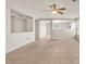Open-concept living area with neutral colors, tile flooring, and seamless flow throughout at 15802 W Watson Ln, Surprise, AZ 85379