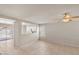 Spacious living room with a ceiling fan and an open view to the kitchen at 15802 W Watson Ln, Surprise, AZ 85379