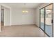 Open floor plan in living and dining area with tile floors and sliding glass door to outdoor space at 15802 W Watson Ln, Surprise, AZ 85379