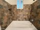 A full bathtub and shower with tiled walls and a window at 1723 W Cheryl Dr, Phoenix, AZ 85021
