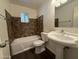 Bathroom with a pedestal sink, tiled shower and bath at 1723 W Cheryl Dr, Phoenix, AZ 85021