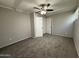 Carpeted bedroom with multiple doors and neutral walls at 1723 W Cheryl Dr, Phoenix, AZ 85021