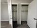 Carpeted room featuring open closets with a single storage shelf at 1723 W Cheryl Dr, Phoenix, AZ 85021