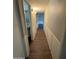 Hallway with wood-look floors and white wainscoting at 1723 W Cheryl Dr, Phoenix, AZ 85021