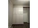 Hallway area featuring white storage cabinets, gray walls, and vinyl floors at 1723 W Cheryl Dr, Phoenix, AZ 85021