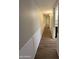 A hallway with light colored walls and brown laminate flooring at 1723 W Cheryl Dr, Phoenix, AZ 85021