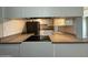 Functional kitchen with a cooktop, ample countertop space, and neutral backsplash for easy updates at 1723 W Cheryl Dr, Phoenix, AZ 85021