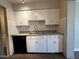 Kitchen with white cabinets, black dishwasher, and plenty of space for cooking and entertaining at 1723 W Cheryl Dr, Phoenix, AZ 85021