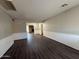Spacious living room featuring wood-look flooring and a glimpse of the fireplace in the background at 1723 W Cheryl Dr, Phoenix, AZ 85021