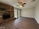 Living area with vinyl flooring, a ceiling fan, and a rock fireplace at 1723 W Cheryl Dr, Phoenix, AZ 85021