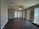 Living area with wood-look floors, a ceiling fan, and exterior access at 1723 W Cheryl Dr, Phoenix, AZ 85021