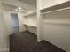Walk-in closet featuring carpet, shelves and rod at 1723 W Cheryl Dr, Phoenix, AZ 85021
