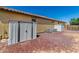 View of backyard with storage sheds, HVAC, and low-maintenance desert landscape featuring red rock at 18658 N Tanners Way, Maricopa, AZ 85138