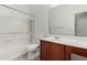 Bright bathroom with a shower-tub combo, vanity, and a large mirror at 18658 N Tanners Way, Maricopa, AZ 85138
