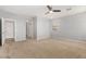 Bright and airy bedroom with plush carpet and ensuite bathroom entrance at 18658 N Tanners Way, Maricopa, AZ 85138