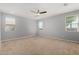Large bedroom with plush carpet and multiple windows allowing for natural light at 18658 N Tanners Way, Maricopa, AZ 85138