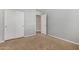 A neutrally painted bedroom with carpet, a ceiling fan, and sliding-door closets at 18658 N Tanners Way, Maricopa, AZ 85138