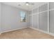Neutral bedroom featuring carpet, a ceiling fan, and built in storage at 18658 N Tanners Way, Maricopa, AZ 85138