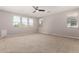 Large bedroom with multiple windows allowing for natural light and plush carpet at 18658 N Tanners Way, Maricopa, AZ 85138