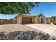 Attractive single-story home with a two-car garage, desert landscaping, and well-kept yard at 18658 N Tanners Way, Maricopa, AZ 85138
