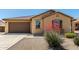Charming single-story home with a well-manicured desert landscape and a two car garage at 18658 N Tanners Way, Maricopa, AZ 85138