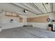 Spacious garage with concrete floors, pegboard, and slat wall storage at 18658 N Tanners Way, Maricopa, AZ 85138