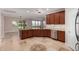 Open kitchen with wood cabinets, granite countertops, stainless steel appliances, and a breakfast bar at 18658 N Tanners Way, Maricopa, AZ 85138