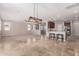 Bright, open-concept living/dining area with tile flooring and breakfast bar at 18658 N Tanners Way, Maricopa, AZ 85138